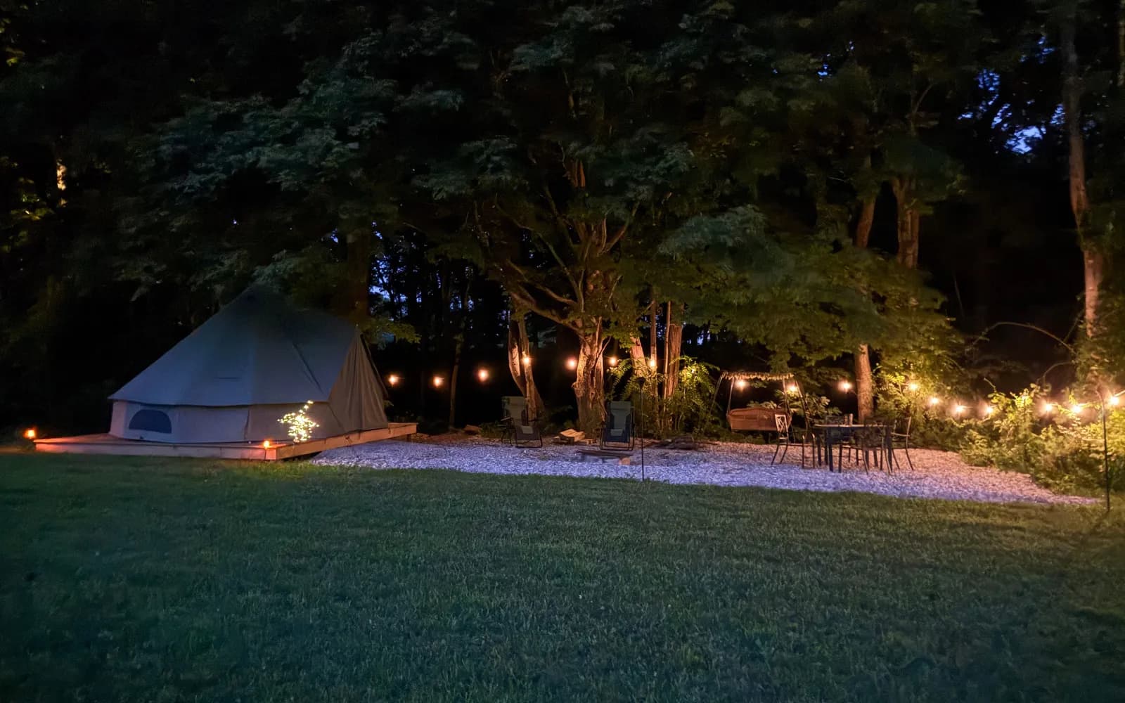 Wooded tent site at dusk